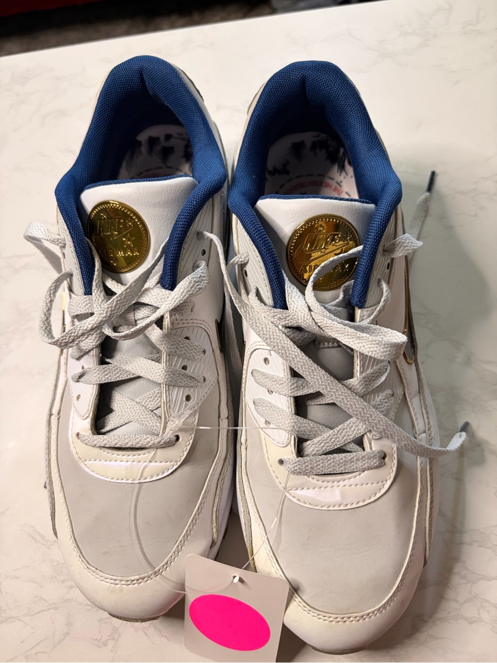 Nike White Sneakers with Blue Liner and Gold Emblem